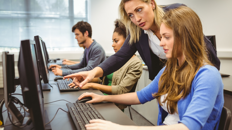 Attractive Teacher Helping Her Student In Computer Class DePaul 